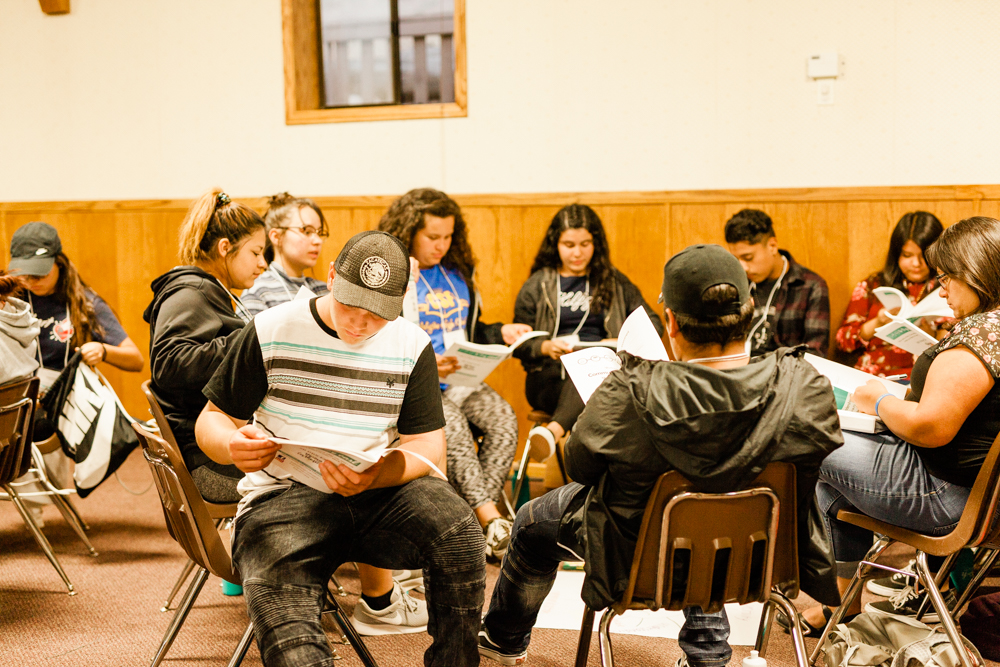 Young people seated together in a reading circle