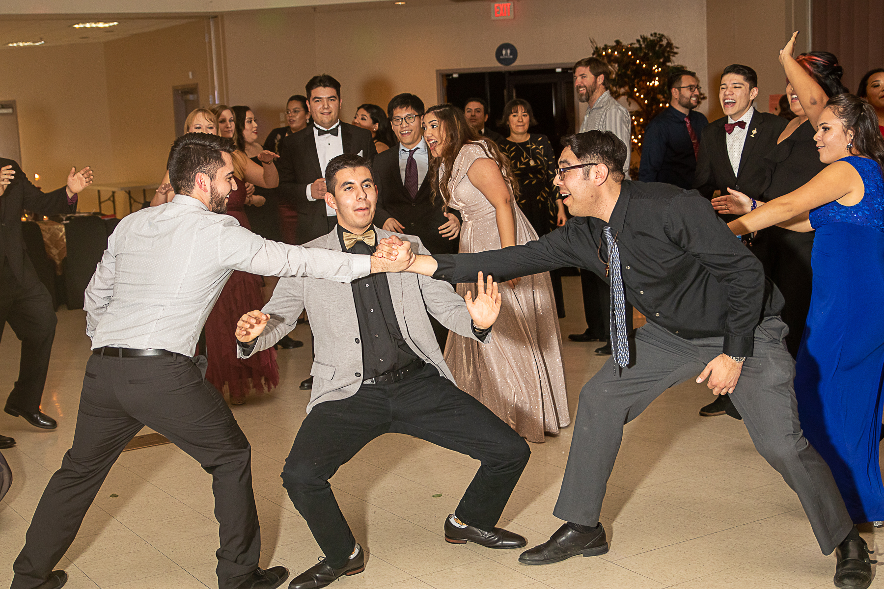 Young adults in formal wear dancing together