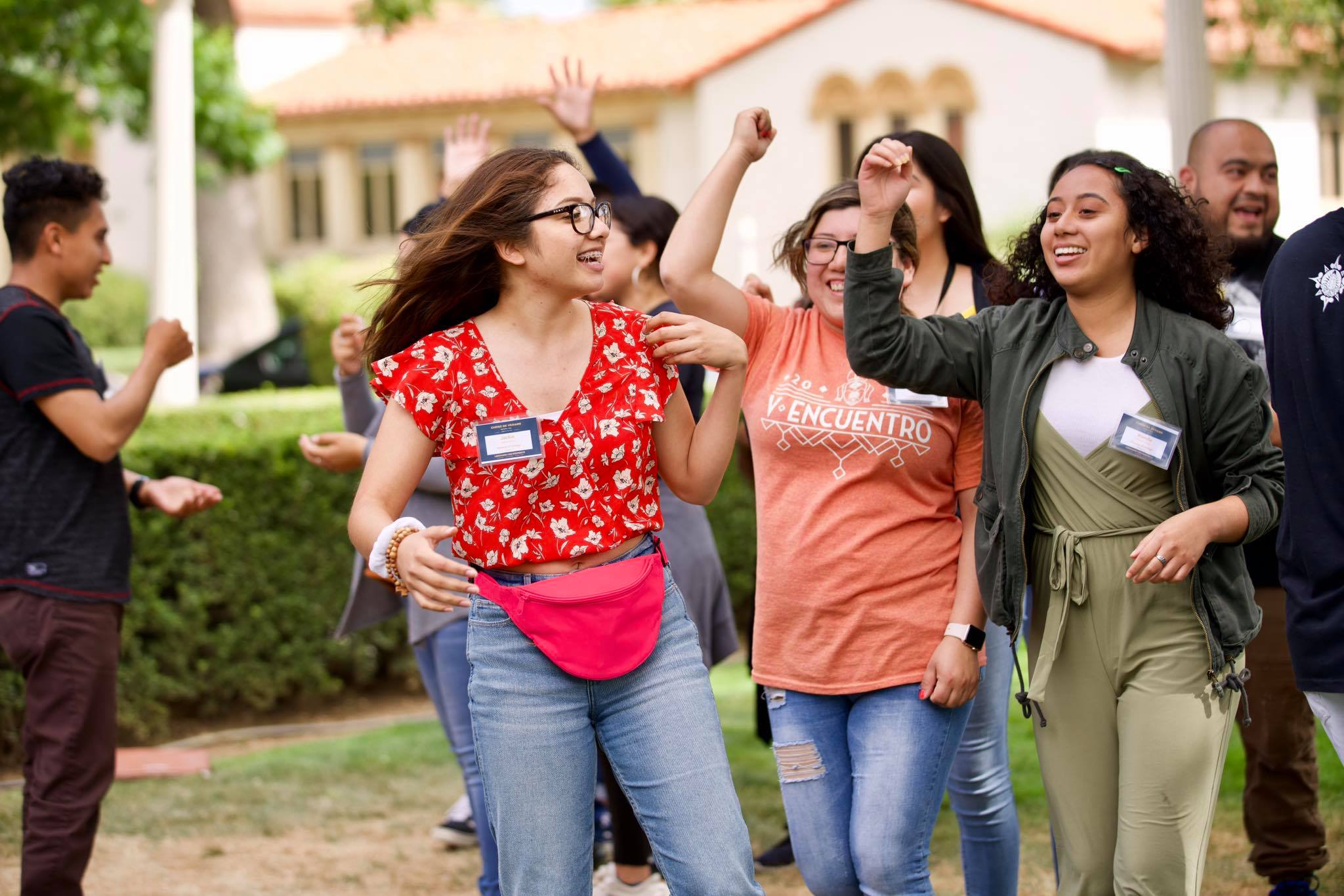 Young adults laughing together on a lawn