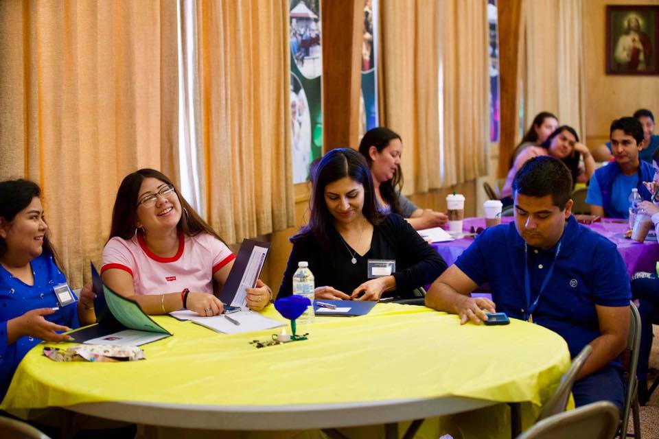 Young people gathered around tables together